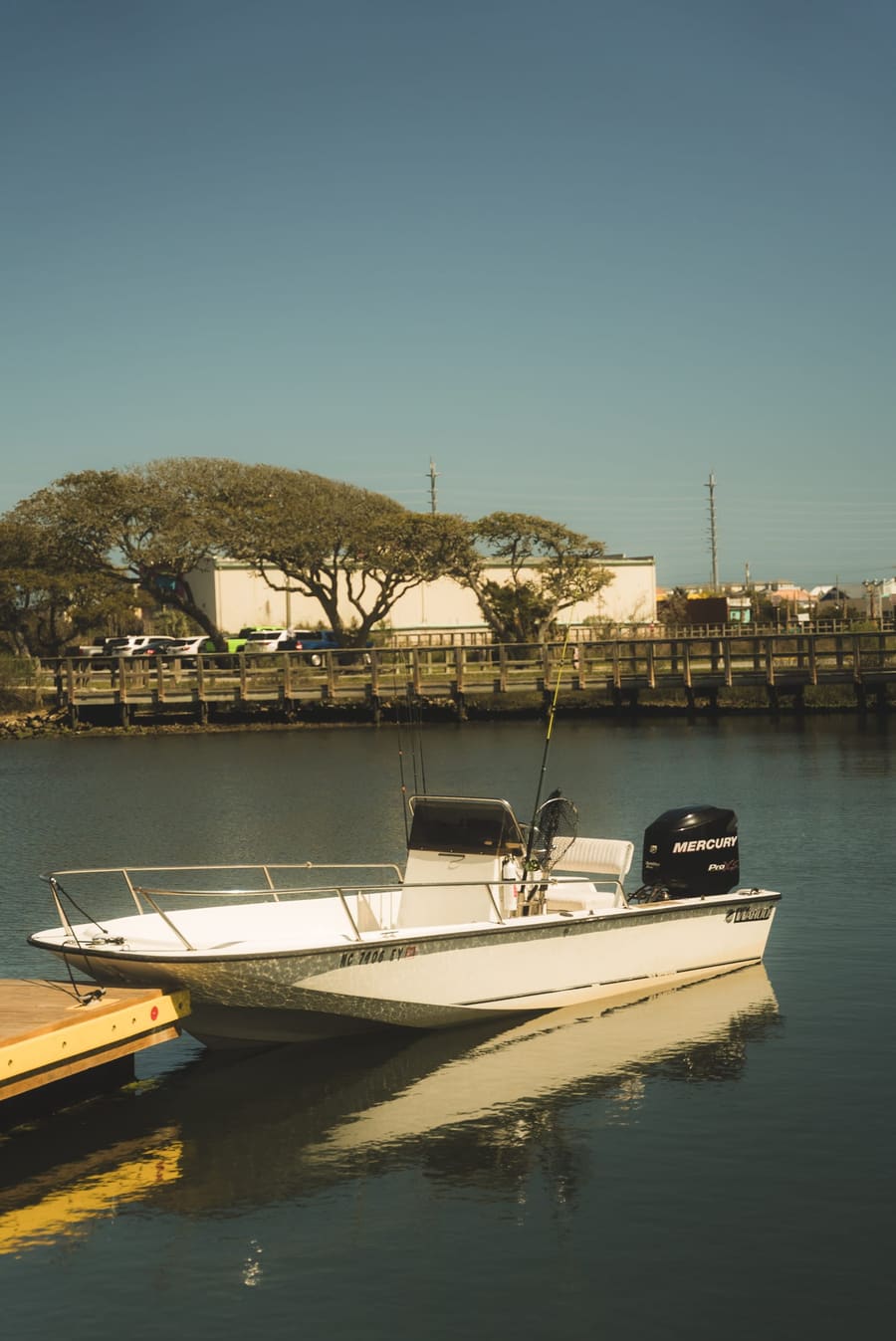 White boat moored at a quiet dock